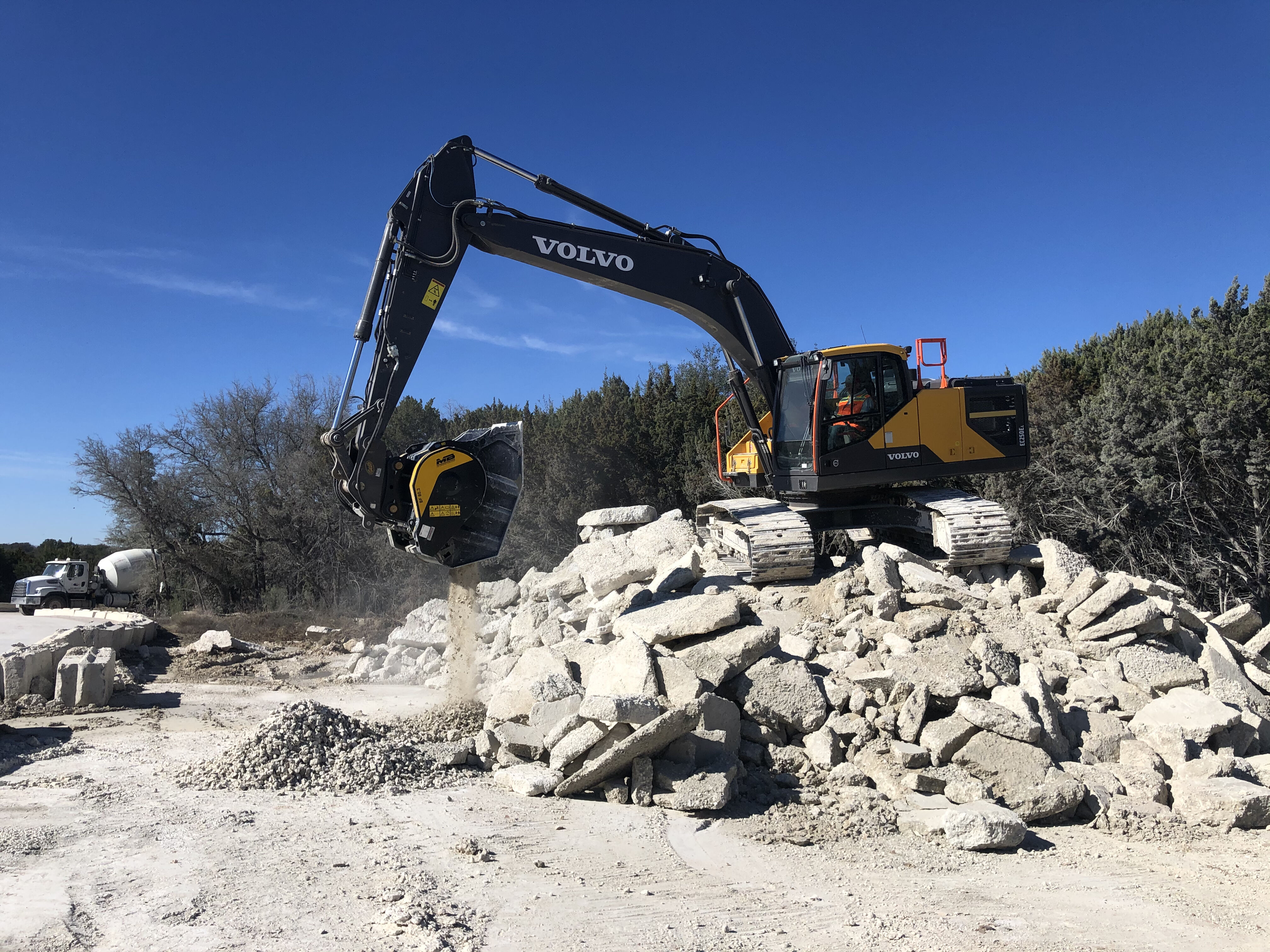 MB Crusher BF80.3 Crusher Bucket recycling concrete washout on-site on a Volvo excavator in the United States to be crushed and reused for road base or backfill.